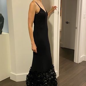 Black gown with satin embellishment at the hem.